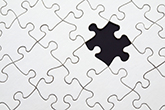 White puzzle pieces with one missing on a black background.