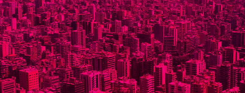 Image of a sprawling city scape with a rubine red overlay