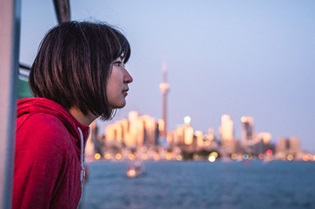 Woman overlooking Toronto Harbour | Click here to learn more